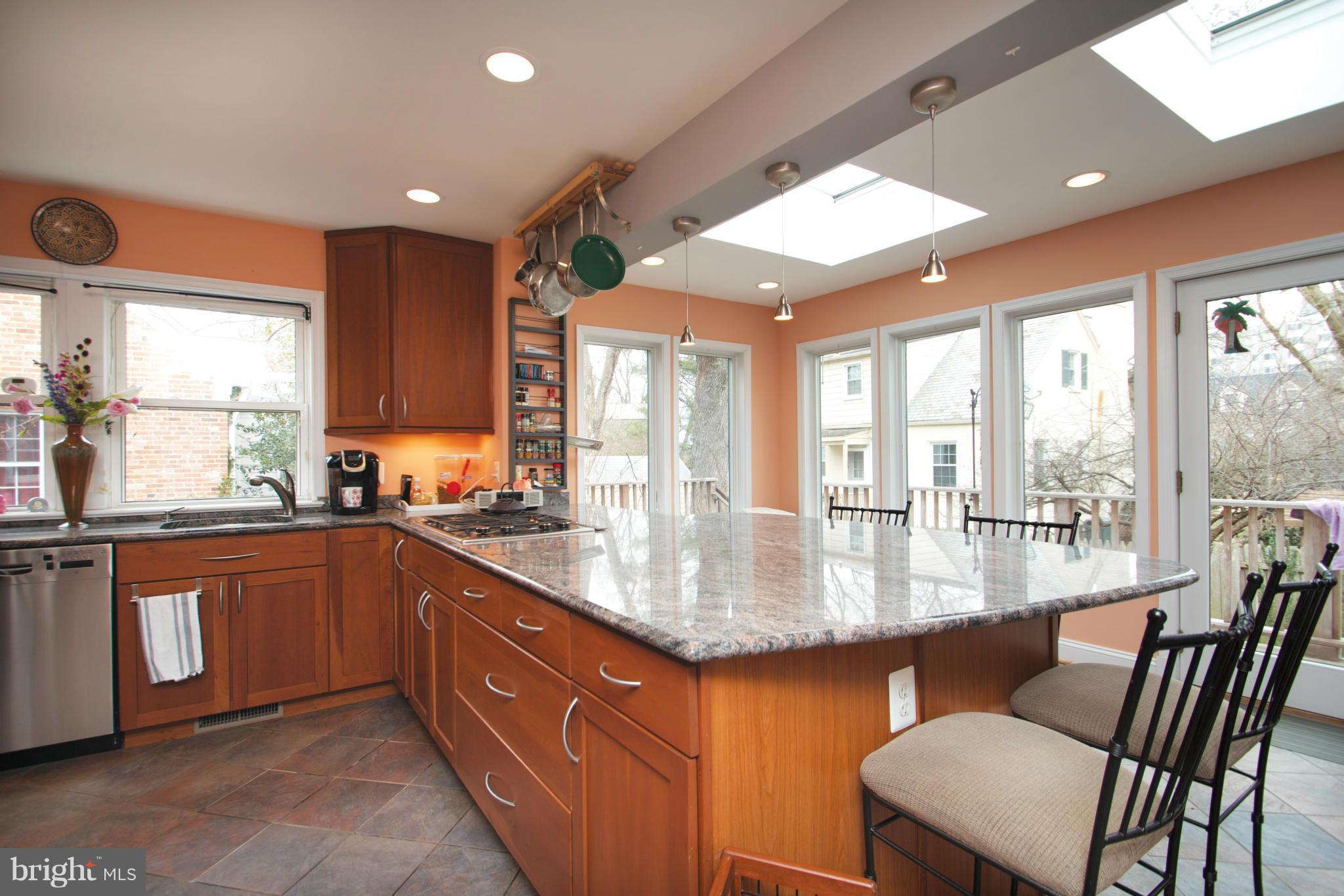 8215 Maple Ridge Road Bethesda, MD 20814 - Photo 4 of 23 a kitchen with stainless steel appliances granite countertop a stove and a sink