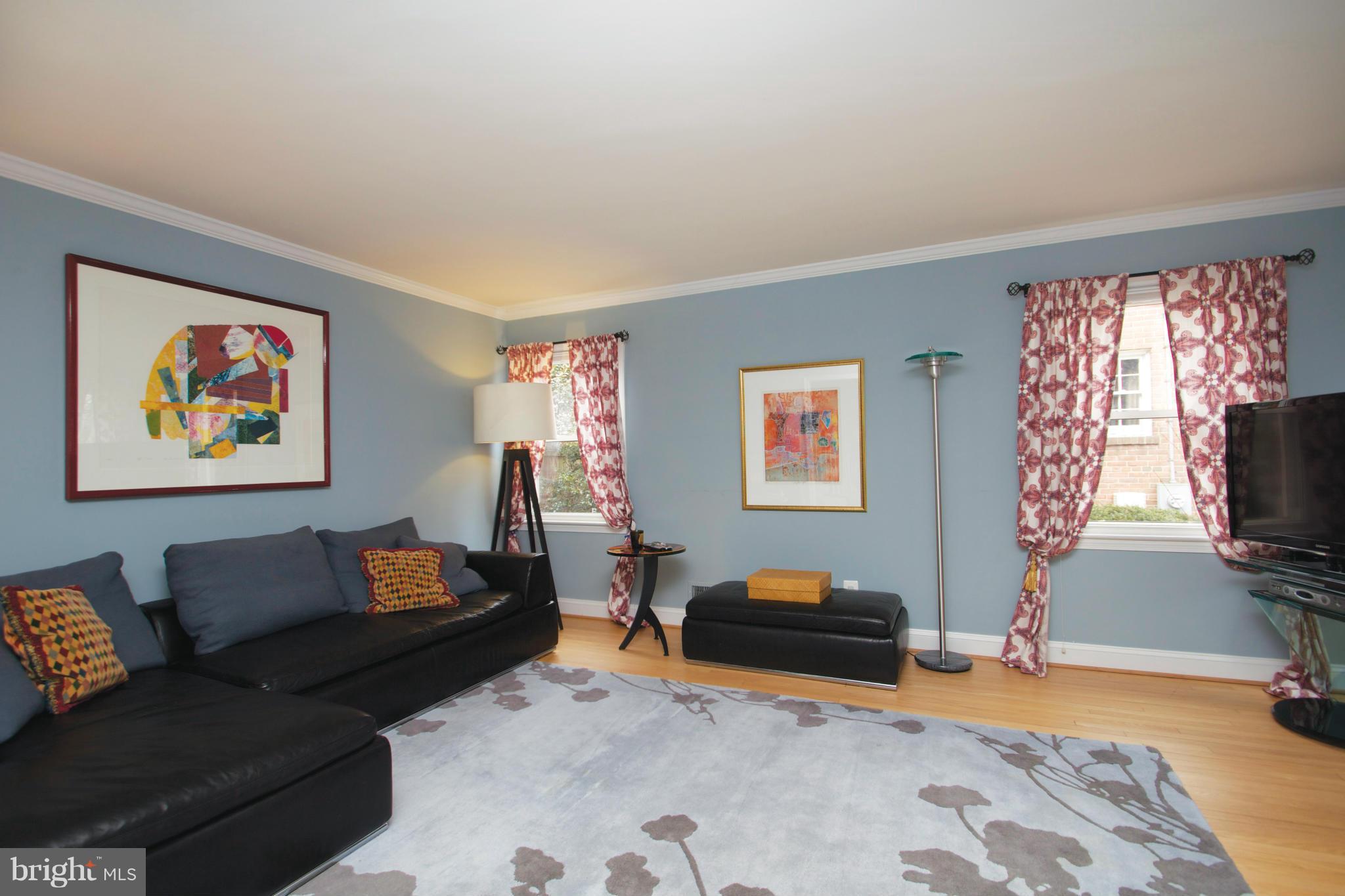 8215 Maple Ridge Road Bethesda, MD 20814 - Photo 9 of 23 a living room with furniture a flat screen tv and a window