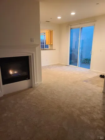 a view of an empty room with a fireplace