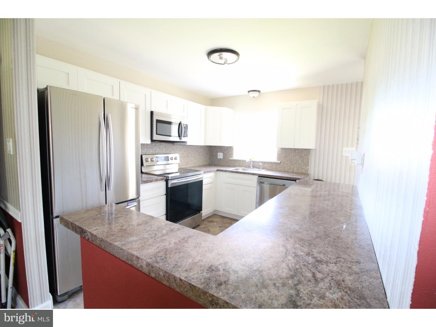 22 Nestler Road Bridgeton, NJ 08302 - Photo 5 of 14 a kitchen with stainless steel appliances granite countertop a sink stove and refrigerator