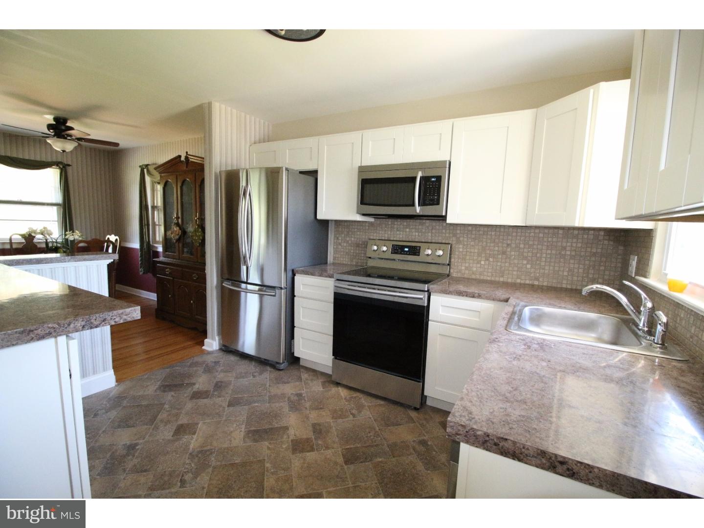 22 Nestler Road Bridgeton, NJ 08302 - Photo 6 of 14 a kitchen with stainless steel appliances granite countertop a refrigerator a stove a sink and a microwave