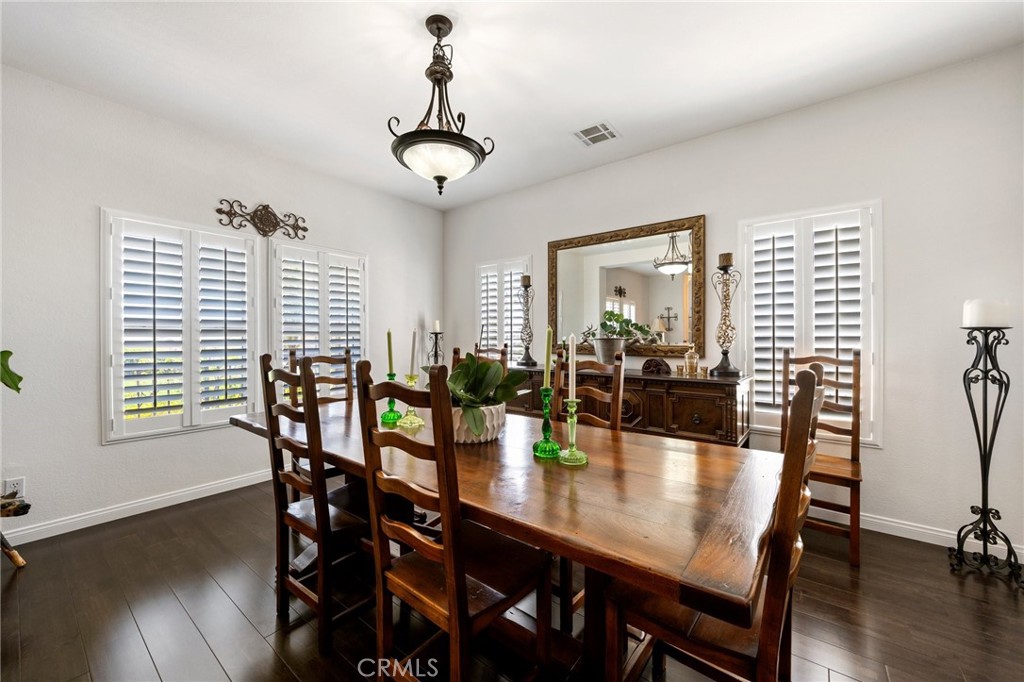 34695 Desert Road Acton, CA 93510 - Photo 29 of 68 a view of a dining room and livingroom with furniture wooden floor a chandelier
