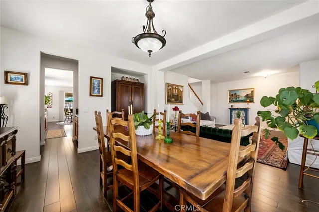 a living room with furniture a piano and a bookshelf