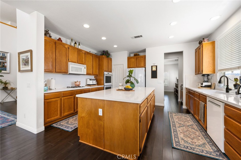 34695 Desert Road Acton, CA 93510 - Photo 33 of 68 a kitchen with stainless steel appliances granite countertop a stove a sink a refrigerator and cabinets