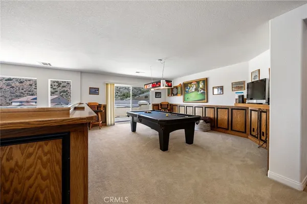 a living room with furniture and a ceiling fan