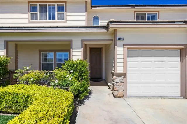 a view of a big house with a big yard and potted plants