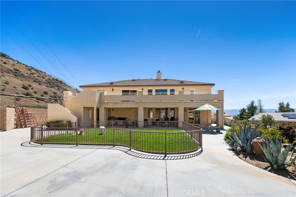 34695 Desert Road Acton, CA 93510 - Photo 6 of 68 a view of a big house with a big yard and potted plants