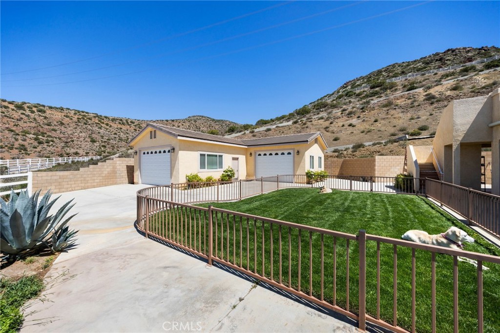 34695 Desert Road Acton, CA 93510 - Photo 7 of 68 a view of a house with a balcony and yard