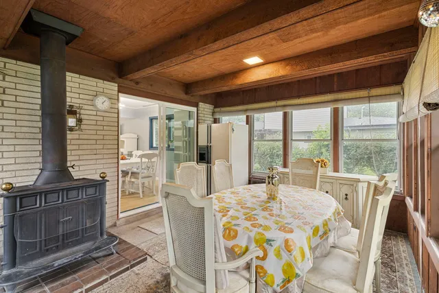 a bedroom with furniture and large windows