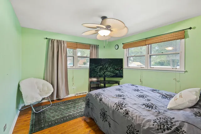 a bed sitting in a bedroom next to a window