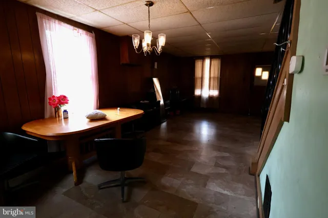 a view of a dining room with furniture and chandelier