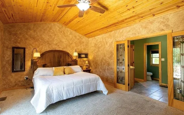 a bedroom with a bed and lamp