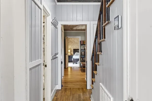 a view of entryway and hall with wooden floor