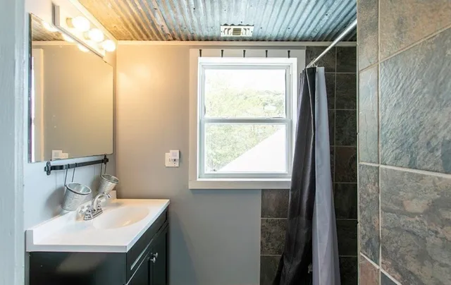 a bathroom with a sink and a mirror