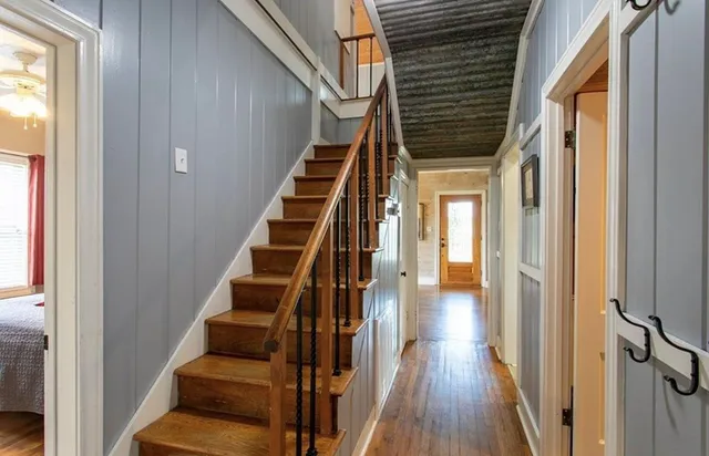 a view of entryway and hall with wooden floor