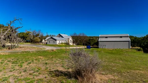 a living room with furniture a fireplace and a chandelier