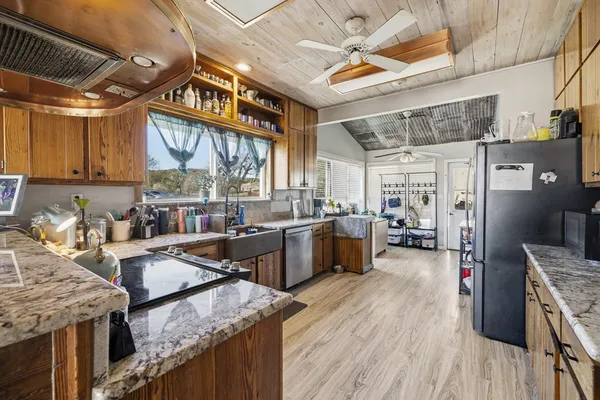a bathroom with a sink vanity granite tub shower and mirror
