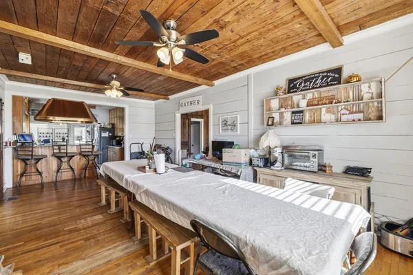 a living room with furniture a bookshelf and a wooden floor