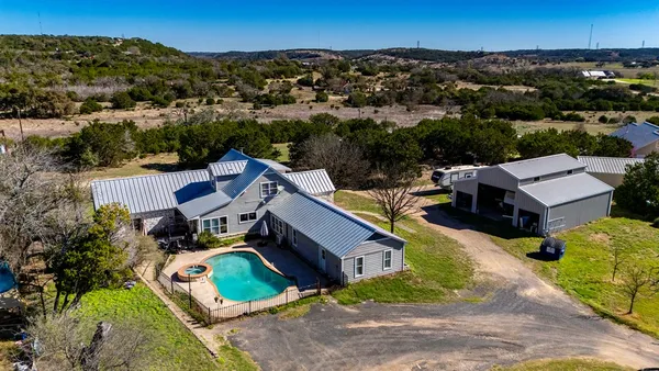 an aerial view of a house with garden space and street view