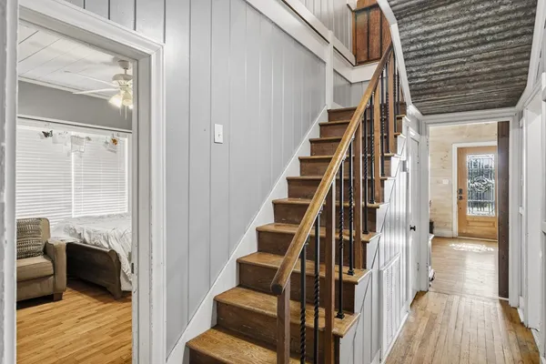 a living room with patio furniture and floor to ceiling windows