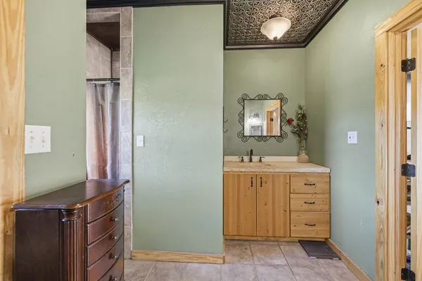 a view of a backyard with table and chairs with wooden fence and plants
