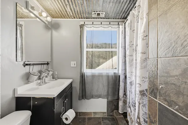 a kitchen with cabinets and wooden floor