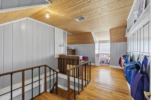 a kitchen with granite countertop a refrigerator a sink dishwasher a stove top oven a refrigerator and cabinets with wooden floor