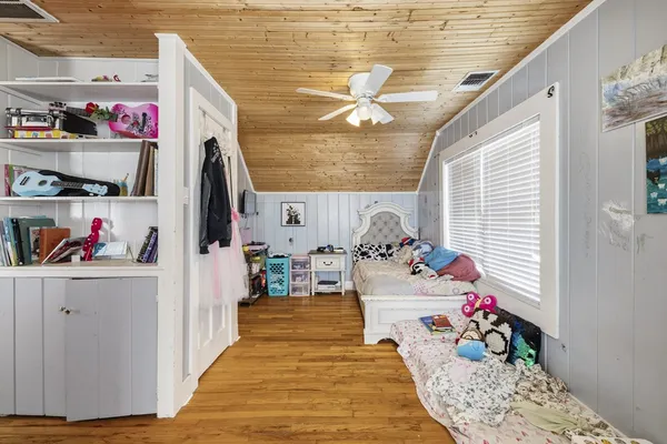 a living room with furniture wooden floor and a large window