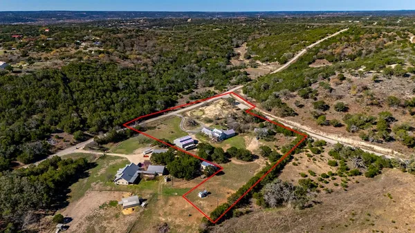 an aerial view of a house with garden space and street view