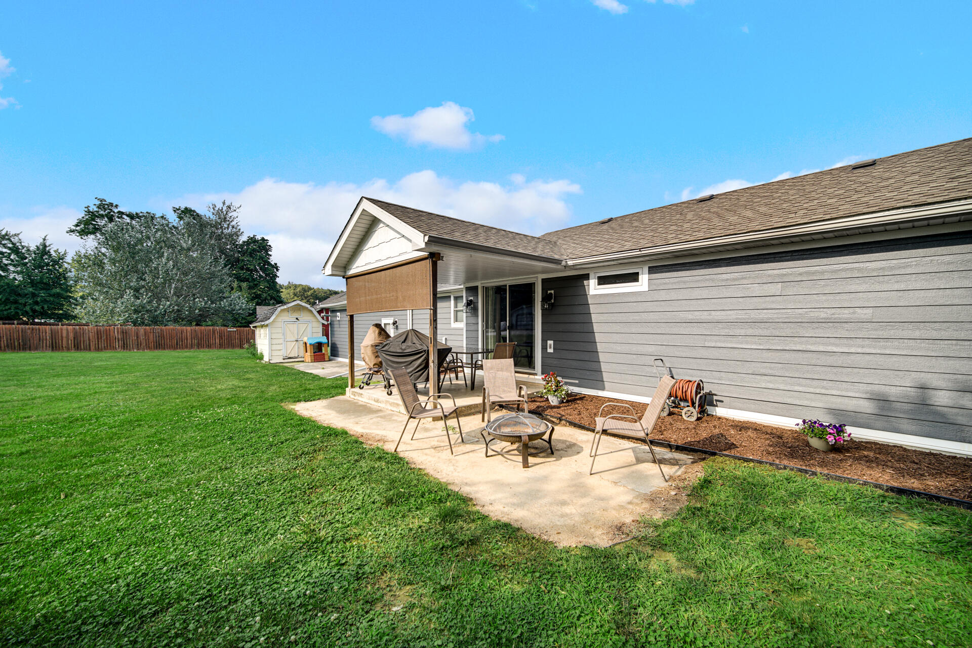 12 South Fish Lake Road Valparaiso, IN 46385 - Photo 18 of 21 a view of a patio with table and chairs under an umbrella