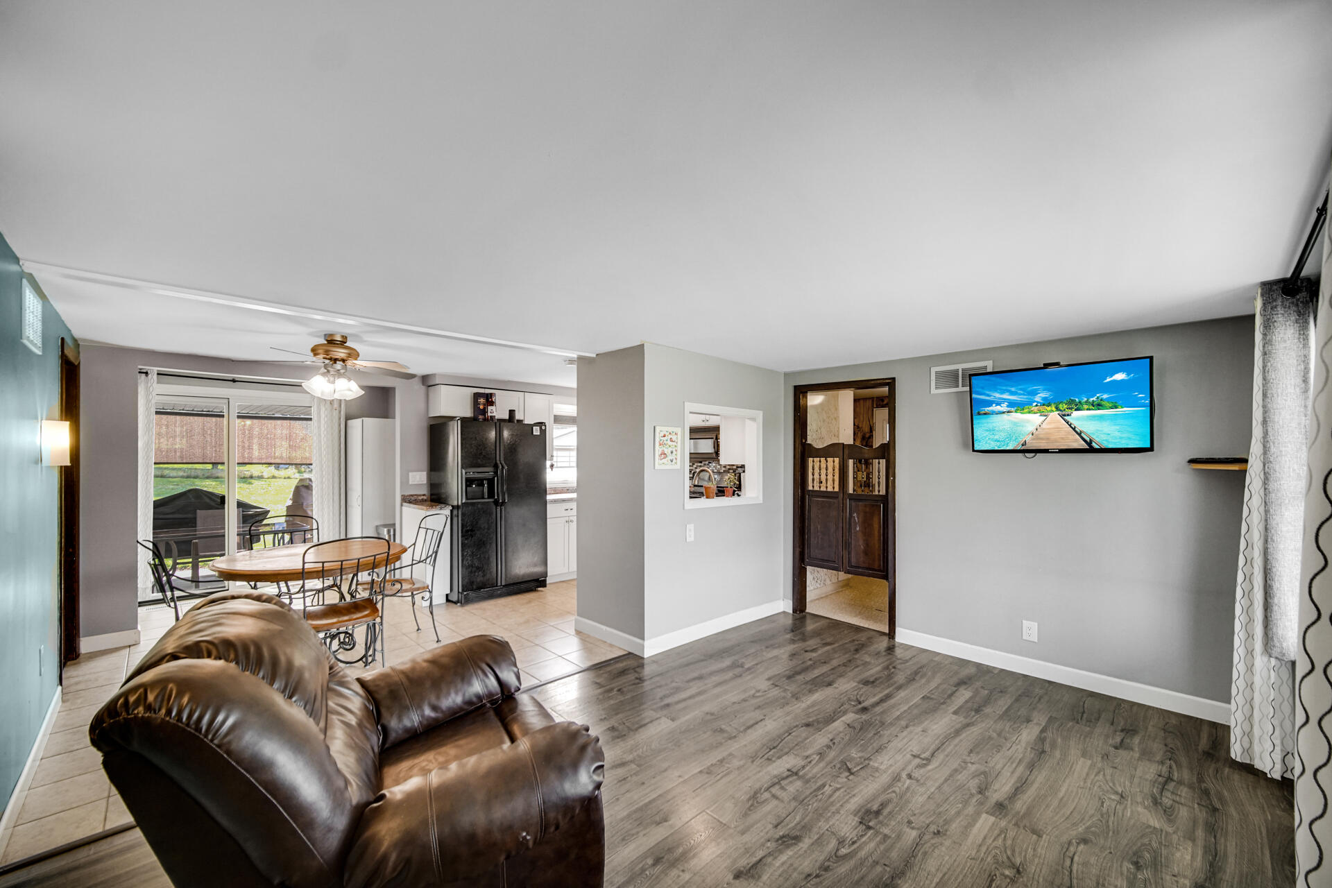 12 South Fish Lake Road Valparaiso, IN 46385 - Photo 2 of 21 a living room with furniture and a flat screen tv
