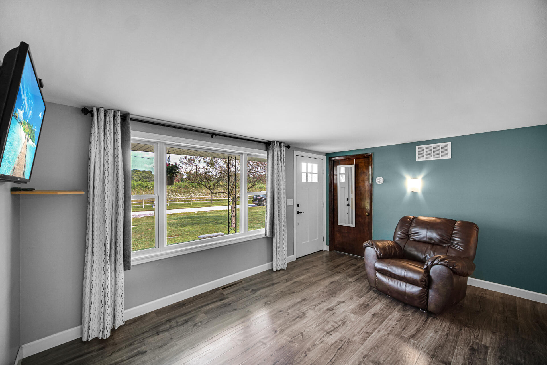 12 South Fish Lake Road Valparaiso, IN 46385 - Photo 3 of 21 a living room with furniture and a flat screen tv