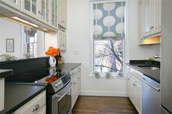 68 Waltham Street, Unit 3 Boston, MA 02118 - Photo 2 of 8 a kitchen with stainless steel appliances granite countertop a sink and a stove