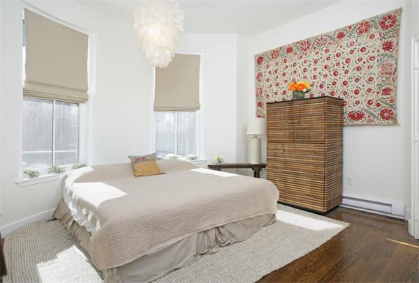 68 Waltham Street, Unit 3 Boston, MA 02118 - Photo 4 of 8 a bedroom with a bed and a painting on the wall