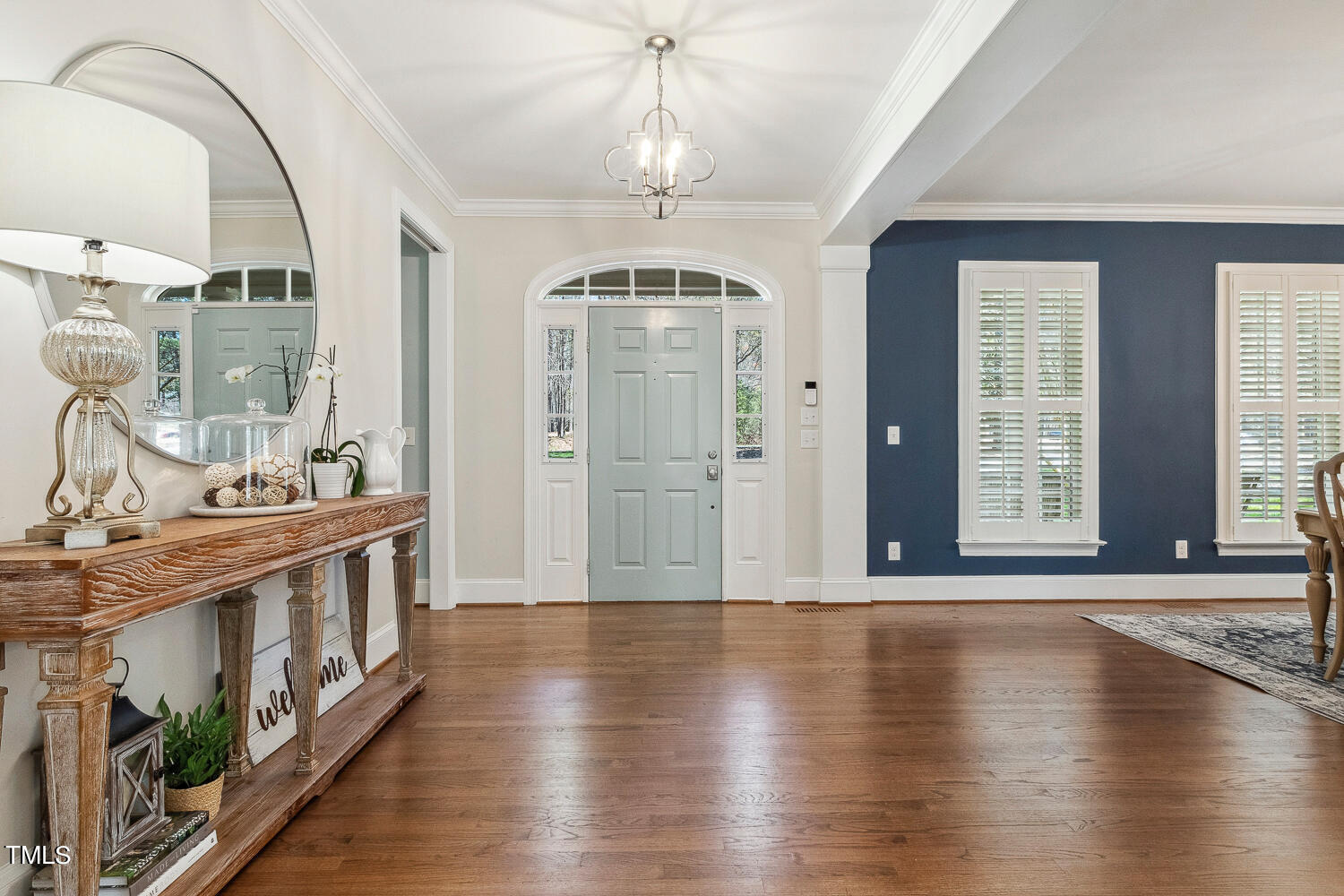 5012 Boulder Creek Lane Raleigh, NC 27613 - Photo 13 of 100 a view of a hallway with wooden floor and a chandelier
