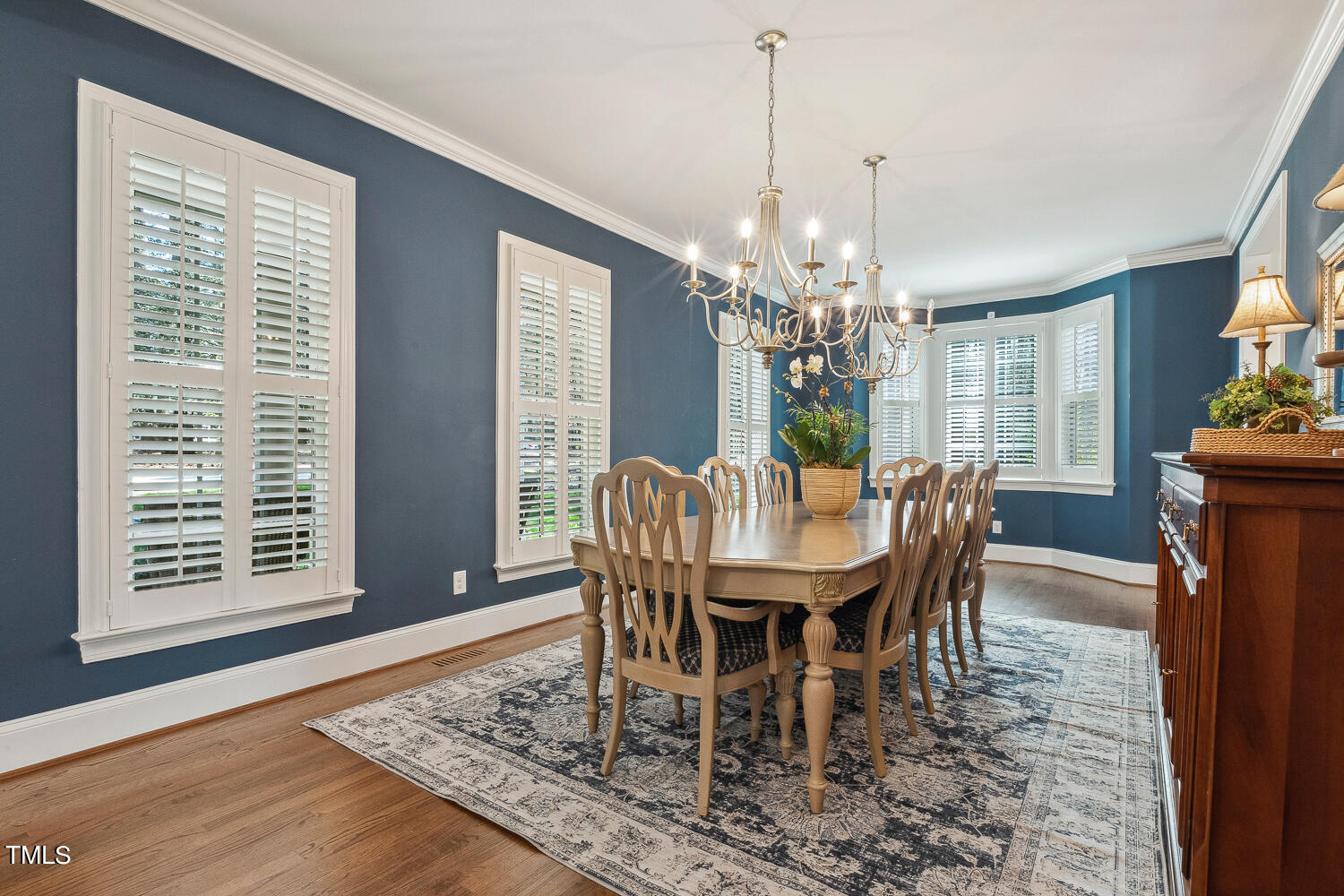 5012 Boulder Creek Lane Raleigh, NC 27613 - Photo 14 of 100 a dining room with furniture a chandelier and wooden floor