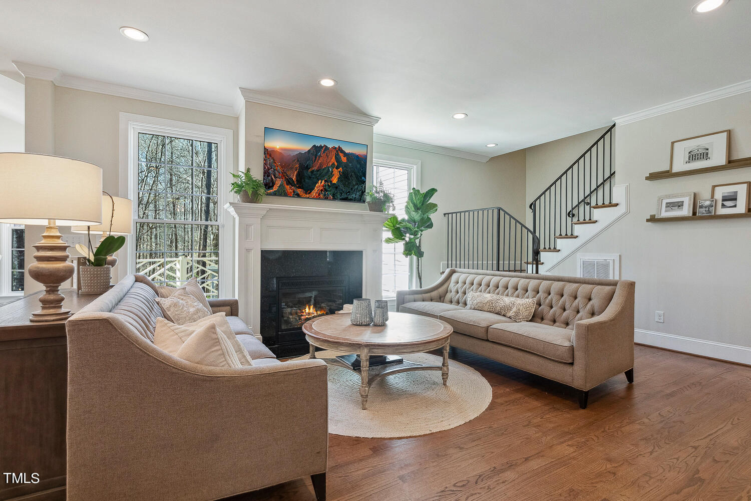 5012 Boulder Creek Lane Raleigh, NC 27613 - Photo 21 of 100 a living room with furniture a flat screen tv and a fireplace