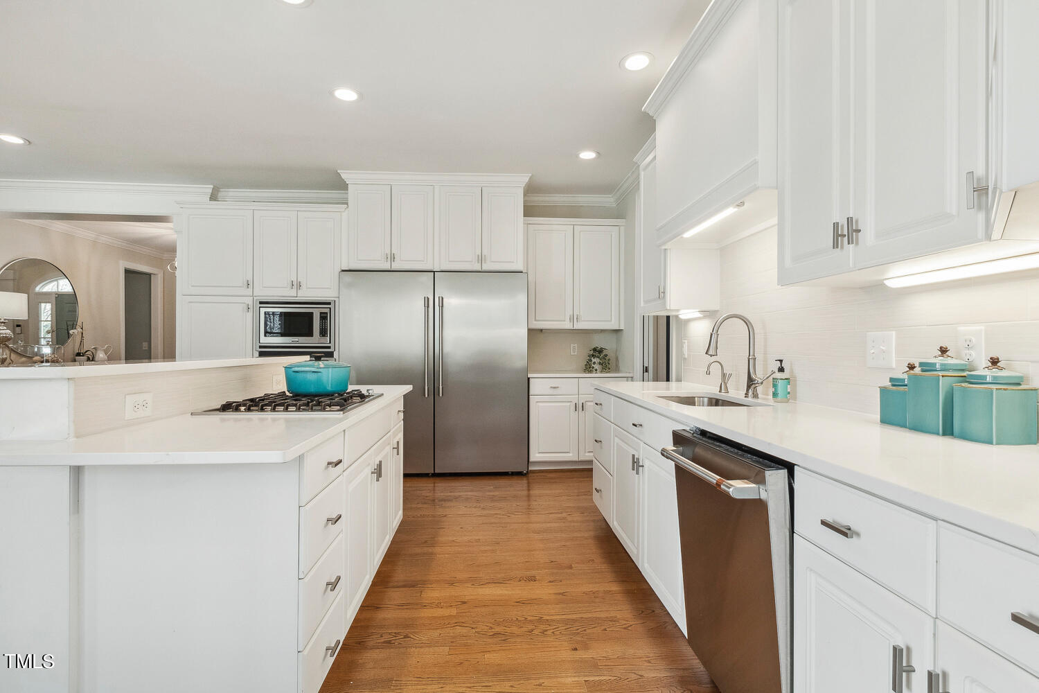 5012 Boulder Creek Lane Raleigh, NC 27613 - Photo 32 of 100 a kitchen with stainless steel appliances a sink stove refrigerator and cabinets