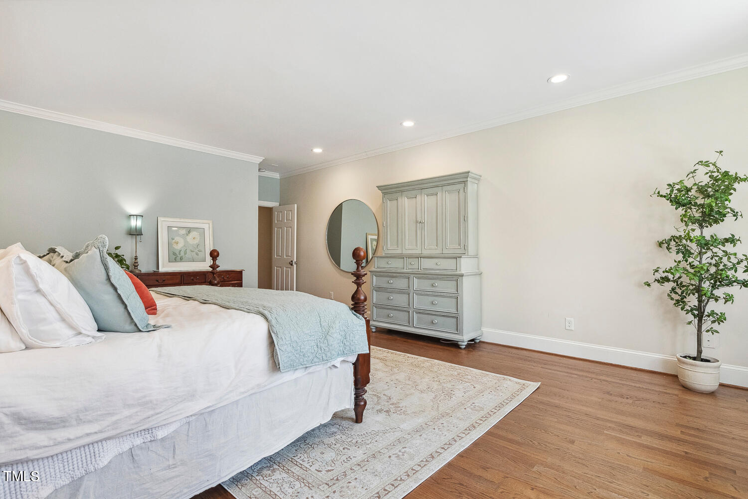 5012 Boulder Creek Lane Raleigh, NC 27613 - Photo 51 of 100 a bed room with a bed and a potted plant