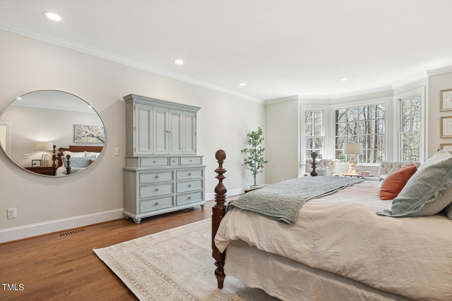 5012 Boulder Creek Lane Raleigh, NC 27613 - Photo 52 of 100 a bedroom with a bed a table and painting on the wall
