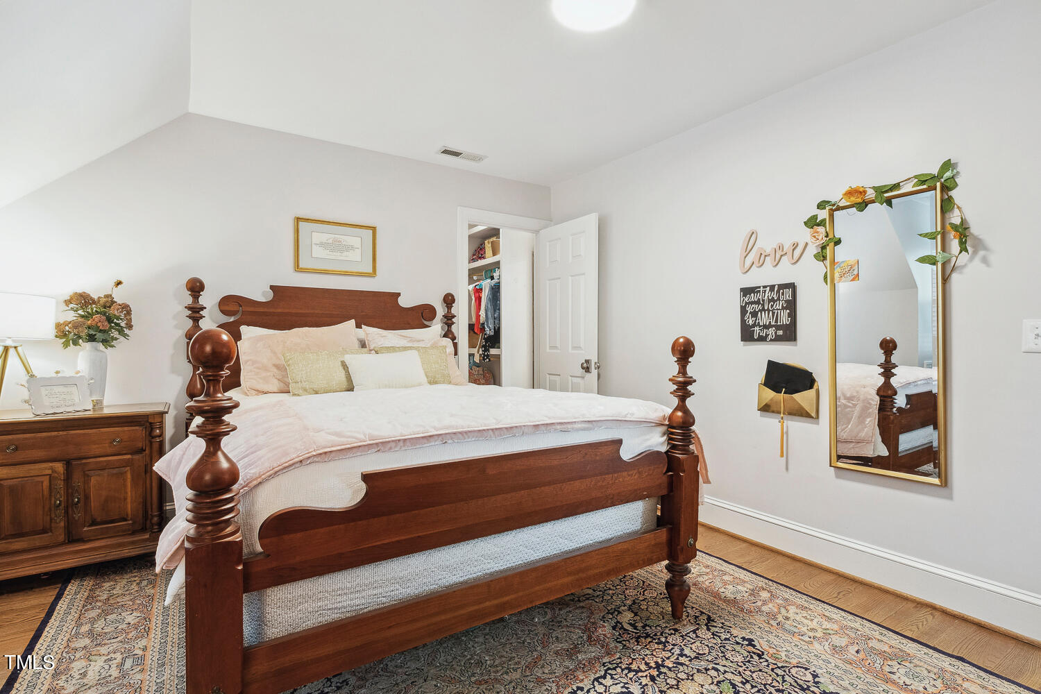 5012 Boulder Creek Lane Raleigh, NC 27613 - Photo 66 of 100 a bedroom with a bed and a chandelier