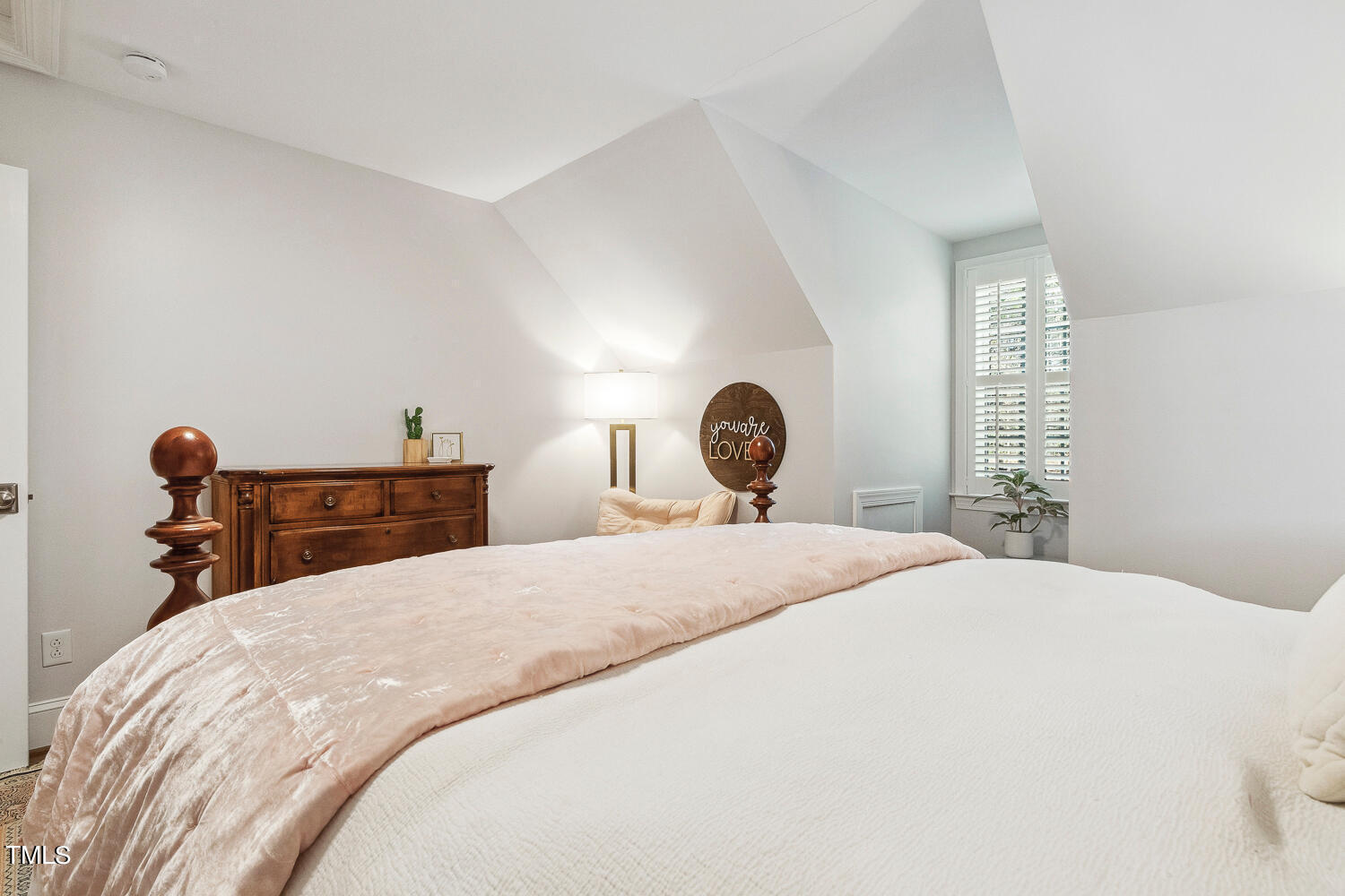 5012 Boulder Creek Lane Raleigh, NC 27613 - Photo 67 of 100 a bedroom with a bed and a chandelier