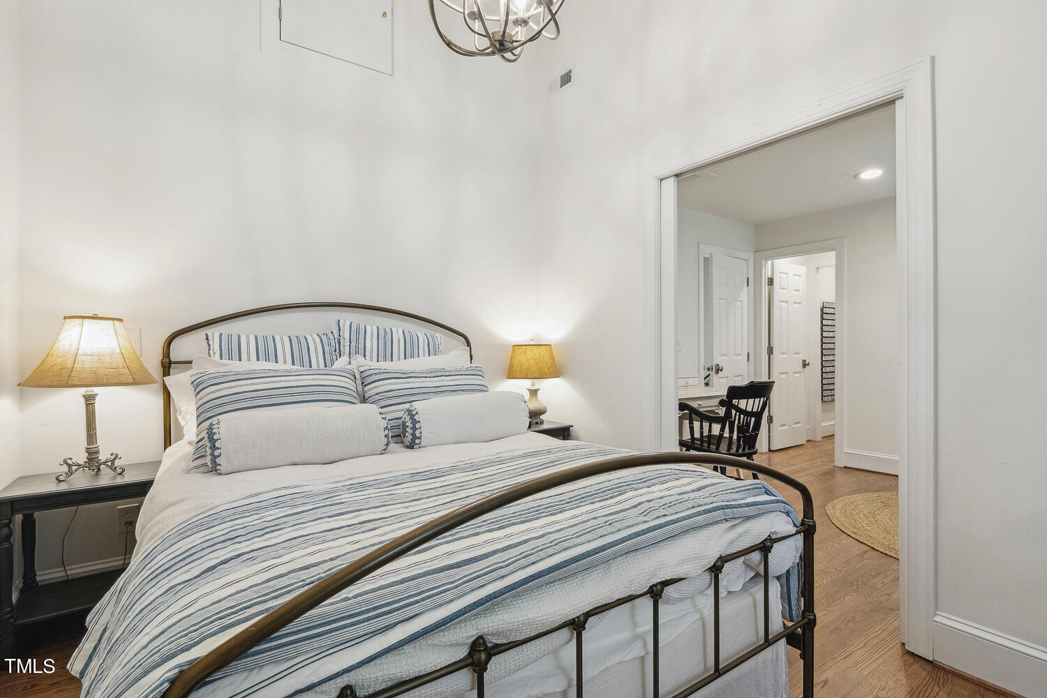 5012 Boulder Creek Lane Raleigh, NC 27613 - Photo 74 of 100 a bedroom with a bed and a chandelier