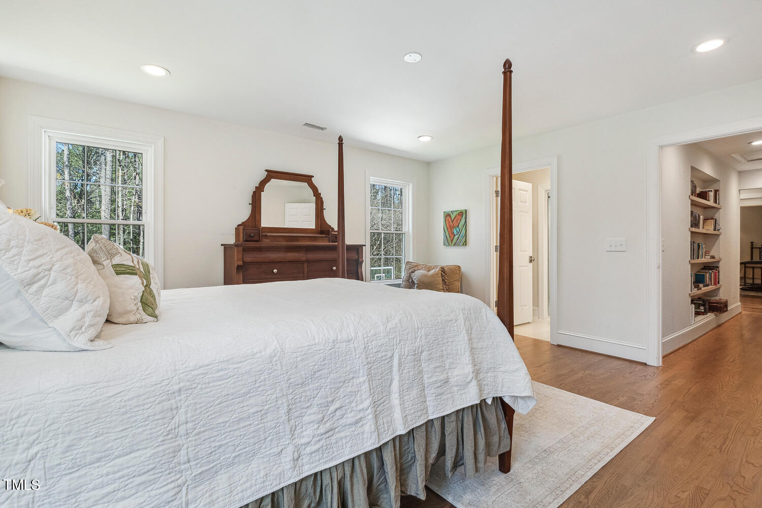 5012 Boulder Creek Lane Raleigh, NC 27613 - Photo 81 of 100 a bedroom with a bed and a dresser with mirror