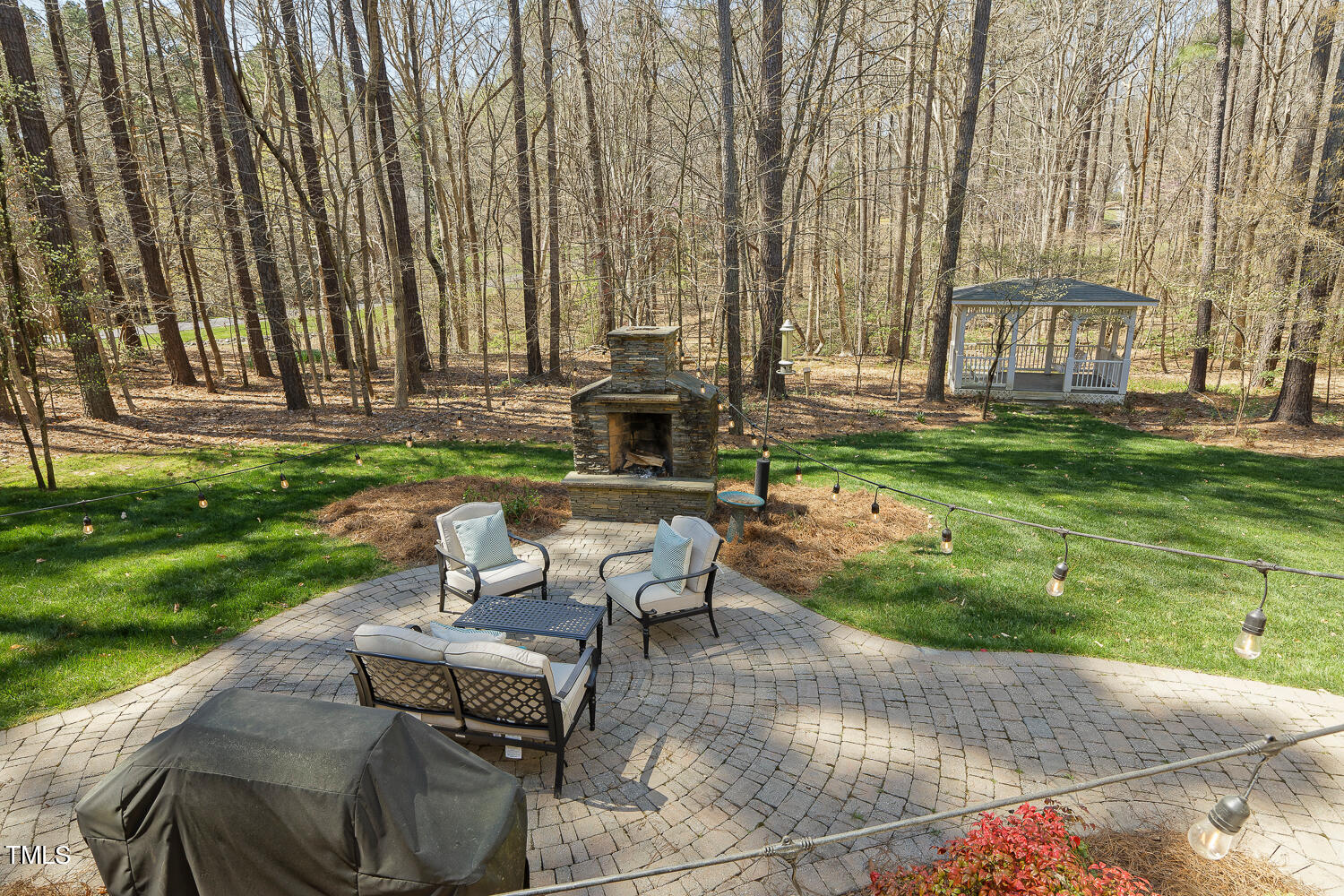 5012 Boulder Creek Lane Raleigh, NC 27613 - Photo 93 of 100 a view of a patio with couches table and chairs with plants and trees
