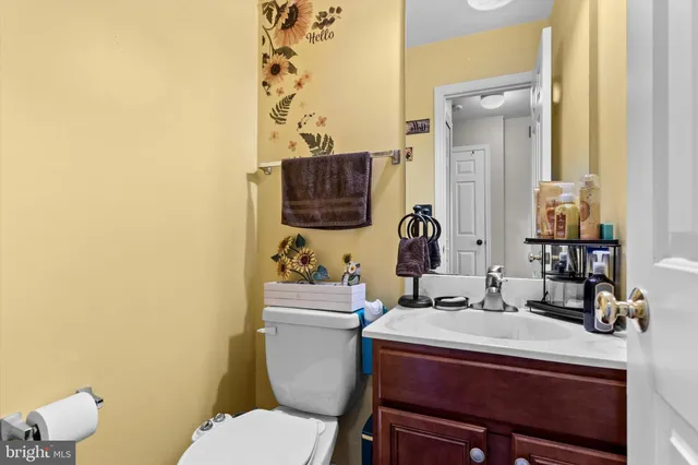 a bathroom with a toilet sink and mirror