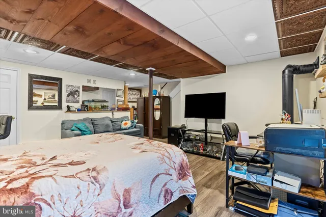 a bedroom with a bed a table and bookshelf