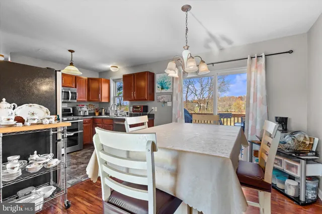 a view of a dining room with furniture a chandelier and wooden floor