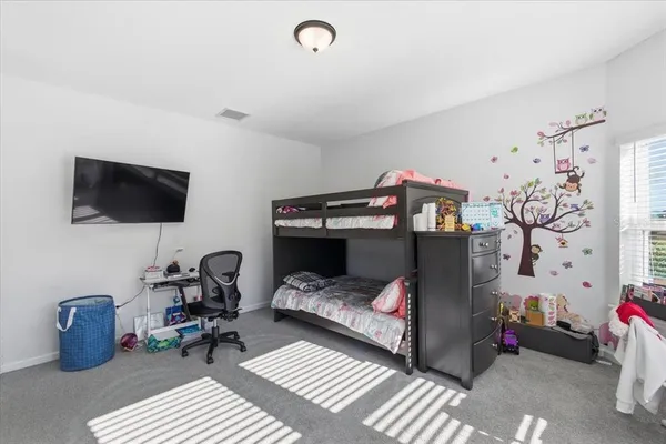 a bedroom with furniture and a window