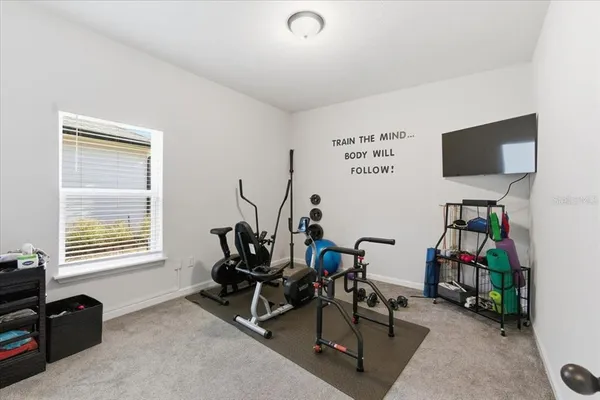 a living room with furniture and a walk in closet